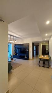 a living room with a table and a dining room at Spacious Abdoun 2BR with private garden & pool access in Amman