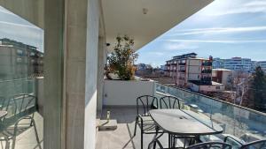 a balcony with a table and chairs and a view at Onix Home Love 203 in Mamaia Sat/Năvodari