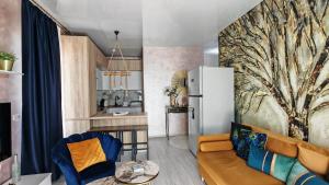 a living room with a couch and a refrigerator at Onix Home Love 203 in Mamaia Sat/Năvodari