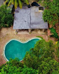 an overhead view of a swimming pool in a yard with trees at Blue Horizon By Capt Logus in Ja-Ela