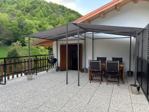 a pavilion with a table and chairs on a patio at al Profilo di Napoleone in San Bartolomeo