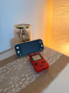 a remote control and a game controller sitting on a table at Schwalbennest in Hiddenhausen