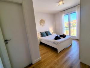 a bedroom with a bed and a large window at Capricho de Rovacías in Comillas +15 photos