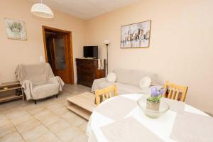 a living room with a table and a couch at K&J House in Didyma