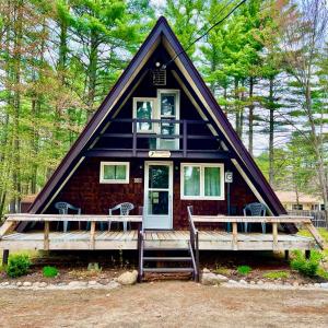 a small house with a gambrel roof at Adorable Aframe in the White Mountains in Conway