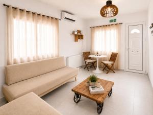 a living room with a couch and a table at Milky house Vrachati in Vrachati