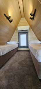 a small room with two beds and a tv at Elysium Lozenets in Lozenets +52 photos