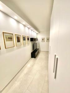 a hallway in a museum with paintings on the walls at Ca' Gregolina in Venice