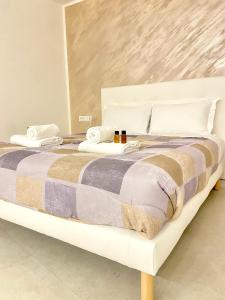 a bed with two towels and pillows on it at Ca' Gregolina in Venice