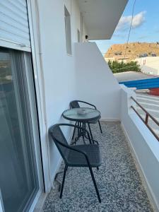 a small table and two chairs on a balcony at ZOGRAFOS 2 in Haraki