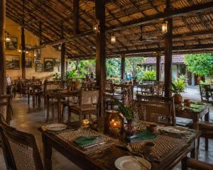 a dining room with tables and chairs in a restaurant at Blue Horizon By Capt Logus in Ja-Ela