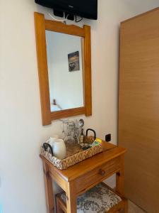 a wooden table with a mirror and a table with a mirror at ZOGRAFOS 2 in Haraki