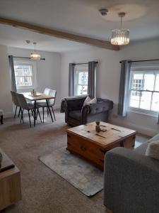 a living room with a couch and a table at Ironbridge town apartment in Ironbridge