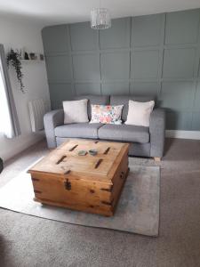 a living room with a couch and a wooden coffee table at Ironbridge town apartment in Ironbridge