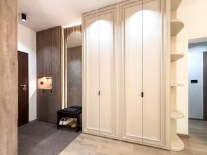 a corridor with white cabinets in a room at SKY Apartment in Sarajevo