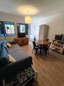 a living room with a couch and a table at La Mauselaine in Gérardmer +7 photos
