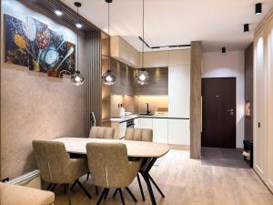 a kitchen and dining room with a table and chairs at SKY Apartment in Sarajevo