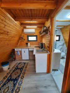 an inside view of a kitchen in a tiny house at Cozy A-Frame Cabins in Bucovina in Şarul Dornei