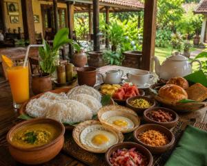 a table with breakfast foods and drinks on it at Blue Horizon By Capt Logus in Ja-Ela +8 photos