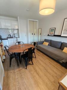 a living room with a table and a couch at La Mauselaine in Gérardmer