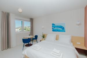 a bedroom with a bed and a table and chairs at áPero Suites in Trogir +289 photos