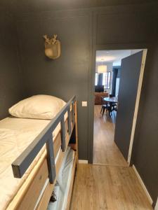 a bedroom with a bunk bed and a dining room at La Mauselaine in Gérardmer