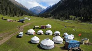an aerial view of a group of domes in a field at Aalam yurt camp Altyn-Arashan in Mineralʼnyy Istochnik Altyn-Arasan