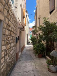 an alley in an old town with buildings at Amber in the centar in Kaštela