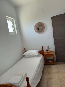 a bedroom with a bed and a mirror on the wall at ZOGRAFOS 1 in Haraki