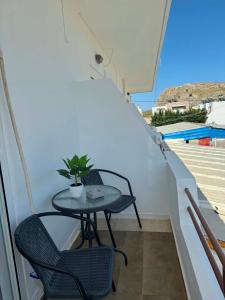 a small table and chairs on a balcony at ZOGRAFOS 1 in Haraki