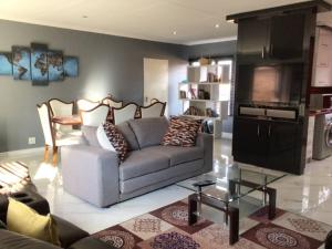 a living room with a couch and a table at Private Secure house in Alberton in Alberton