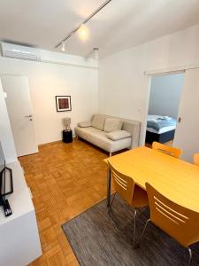 a living room with a table and a couch at Apartments Rombon in Bovec