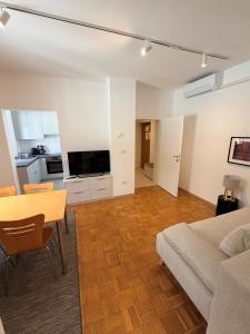 a living room with a table and a couch at Apartments Rombon in Bovec