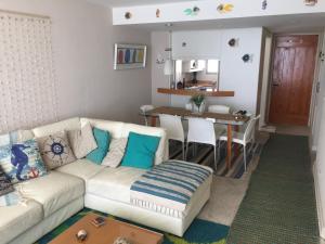 a living room with a couch and a table at San Alfonso del Mar Edificio Goleta in Algarrobo