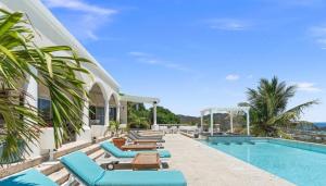 a resort with a swimming pool and lounge chairs at villa coralia - panoramic view in Saint Martin