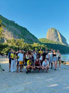 a group of people posing for a picture at the beach at Ipanema Beach Hostel in Rio de Janeiro