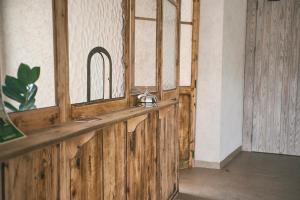 a wooden bar in a room with a mirror at Can Alemany in Santa Margarita de Mombúy