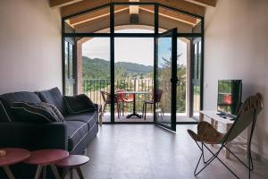 a living room with a couch and a table at Can Alemany in Santa Margarita de Mombúy