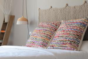a group of pillows sitting on a bed at Can Alemany in Santa Margarita de Mombúy