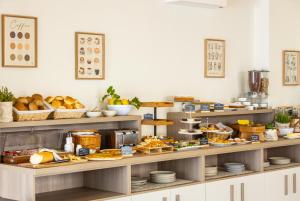 a bakery with a variety of food on shelves at Le Cale in Santa Maria Navarrese +43 photos