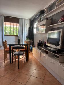 a living room with a table and a television at Villa Maria Mercedes in Olesa de Bonesvalls