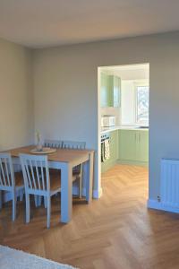 a kitchen and dining room with a table and chairs at Coastal Cottage NC500 in Castletown +4 photos