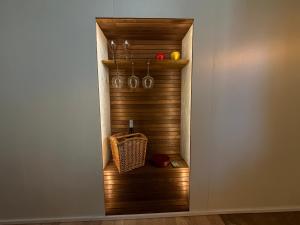 a walk in closet with a wooden wall at Viesu māja Gulbji in Bigauņciems
