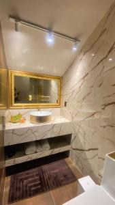 a bathroom with a sink and a mirror at Chalés e suítes vila verde in São Bento do Sul +20 photos
