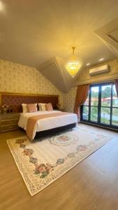 a bedroom with a large bed and a large rug at Chalés e suítes vila verde in São Bento do Sul