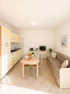 a living room with a couch and a table at RESIDENCE STEFANIA - AGENZIA COCAL in Caorle