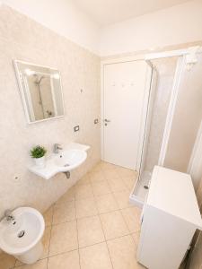 a bathroom with a sink and a toilet and a shower at RESIDENCE STEFANIA - AGENZIA COCAL in Caorle
