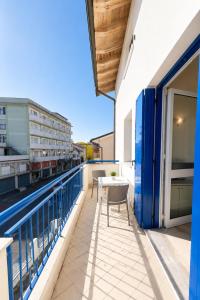 a balcony with a table and chairs on a building at RESIDENCE STEFANIA - AGENZIA COCAL in Caorle