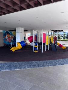 a playground with colorful slides and play equipment at K Avenue by Stay & Unwind Suites in Donggongon