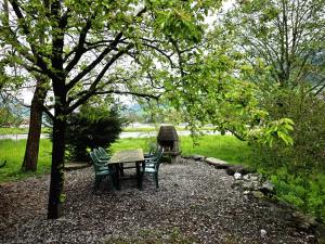 a picnic table and chairs under a tree in a park at privates Ferienhaus Lungern see-you in Lungern